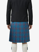 Person wearing a black jacket and blue plaid kilt on a white background