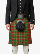 Person wearing a red and green plaid kilt with a black jacket on a white background