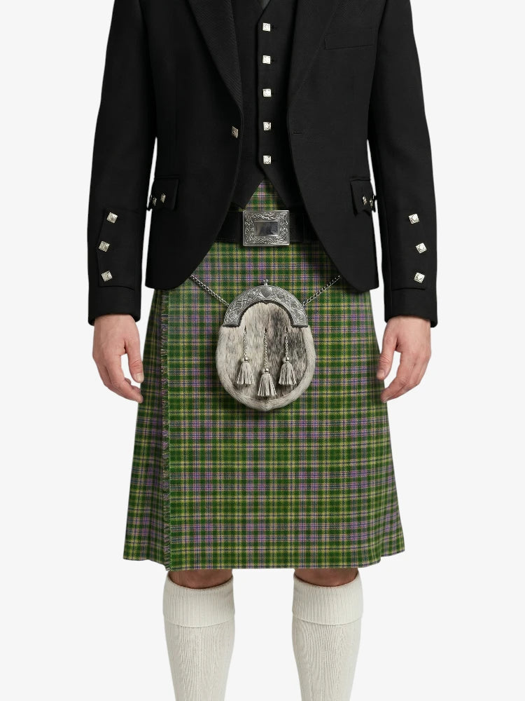 Person wearing a green plaid kilt with a black jacket on a white background