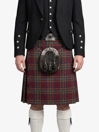 Person wearing a traditional Scottish kilt with a patterned sporran on a white background