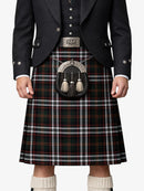 Person wearing a traditional Scottish kilt with a dark jacket and white socks.