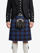 Person wearing a traditional Scottish kilt with a sporran on a white background