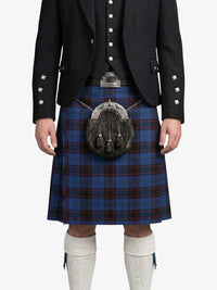 Person wearing a traditional Scottish kilt with a sporran on a white background