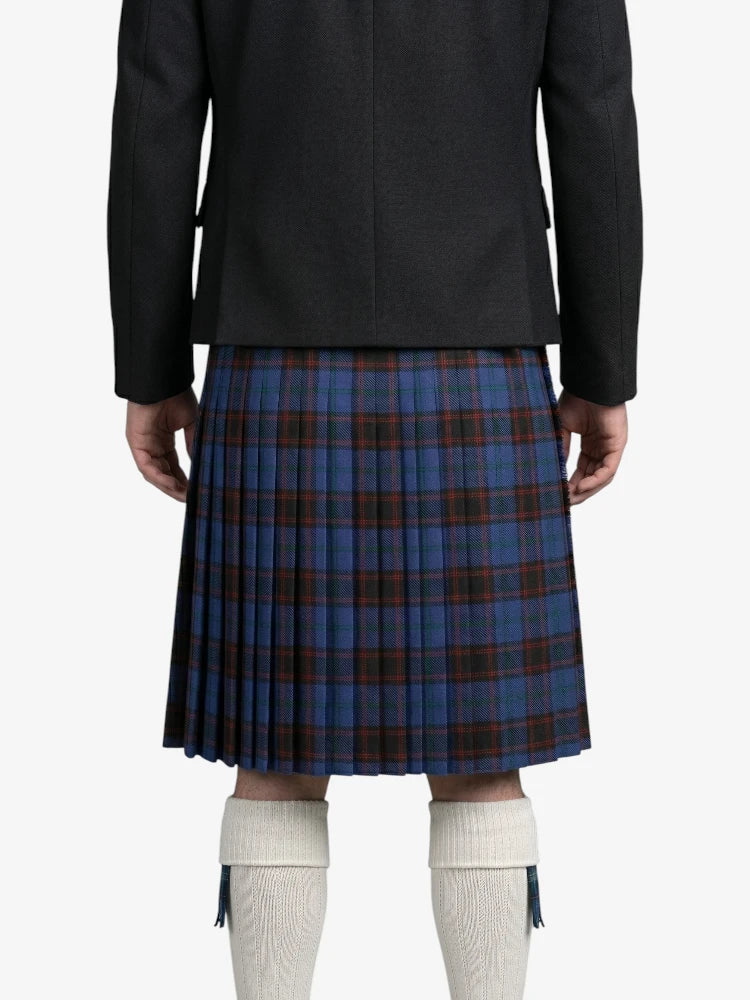 Person wearing a black coat and blue plaid kilt on a white background