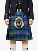 Person wearing a traditional Scottish kilt with a tartan pattern on a white background
