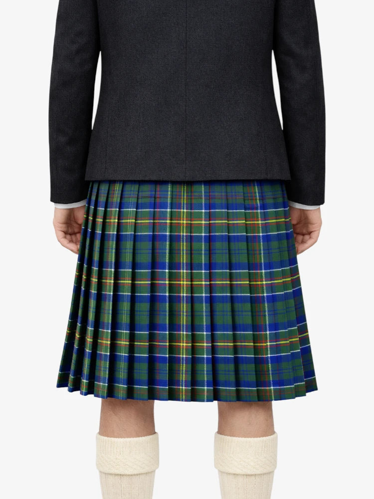 Person wearing a black jacket and blue and green plaid kilt on a white background