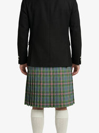 Person wearing a black jacket and plaid kilt on a white background