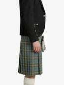Person wearing a black blazer and plaid kilt on a white background