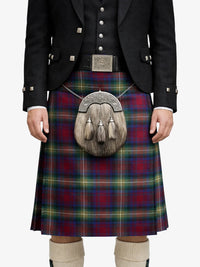 Person wearing a traditional Scottish kilt with a tartan pattern on a white background