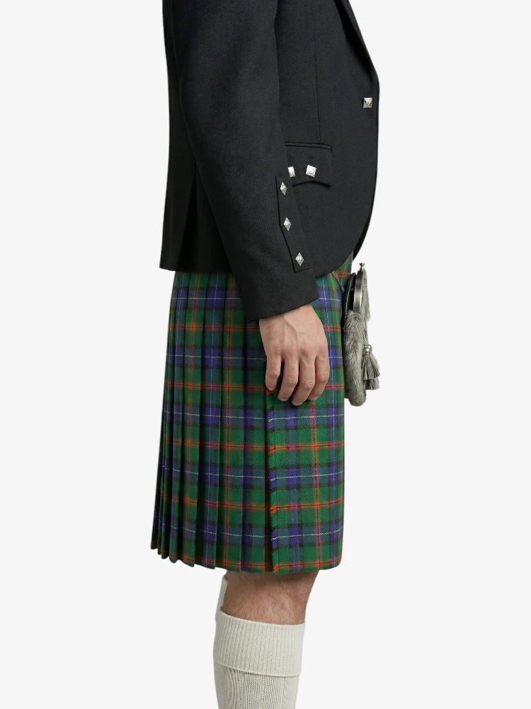 Person wearing a black jacket and green plaid kilt on a white background
