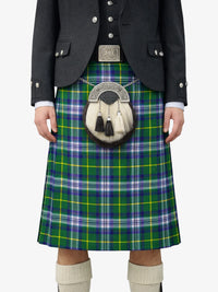 Person wearing a green plaid kilt with a black jacket and white socks on a white background