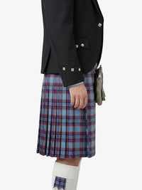 Person wearing a black jacket and blue plaid kilt on a white background