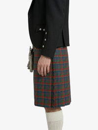 Person wearing a black jacket and plaid kilt on a white background