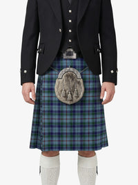 Person wearing a traditional Scottish kilt with a tartan pattern on a white background