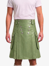 A person wearing a sage green faux-leather kilt with silver-tone decorative buttons and side flap pockets, paired with a light pink t-shirt against a plain white background.