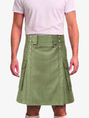 A person wearing a light pink t-shirt and a sage green faux-leather kilt with silver-tone hardware and side cargo pockets, shown against a plain light gray background.