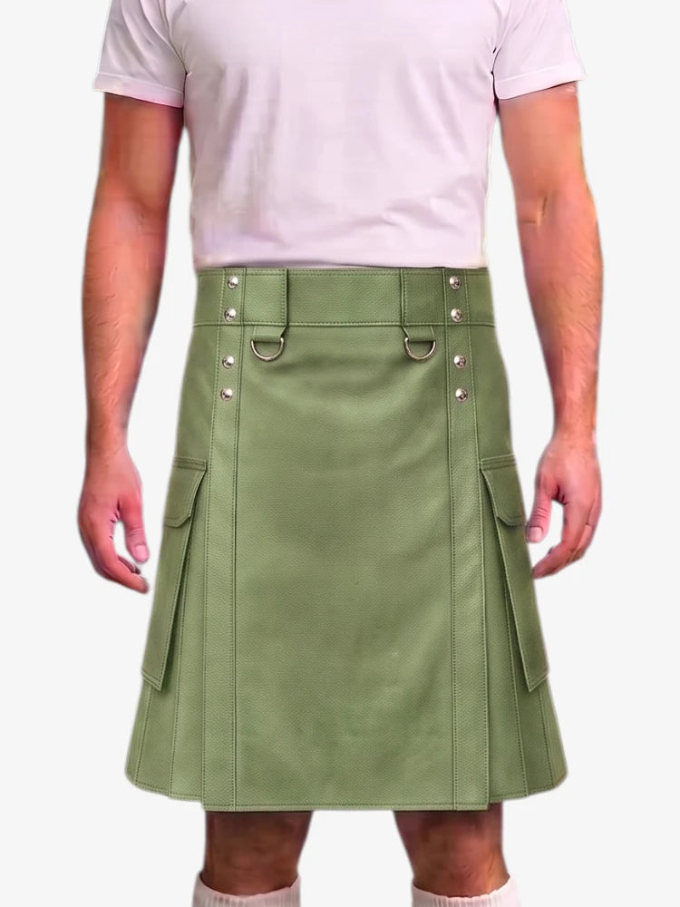 A person wearing a light pink t-shirt and a sage green faux-leather kilt with silver-tone hardware and side cargo pockets, shown against a plain light gray background.