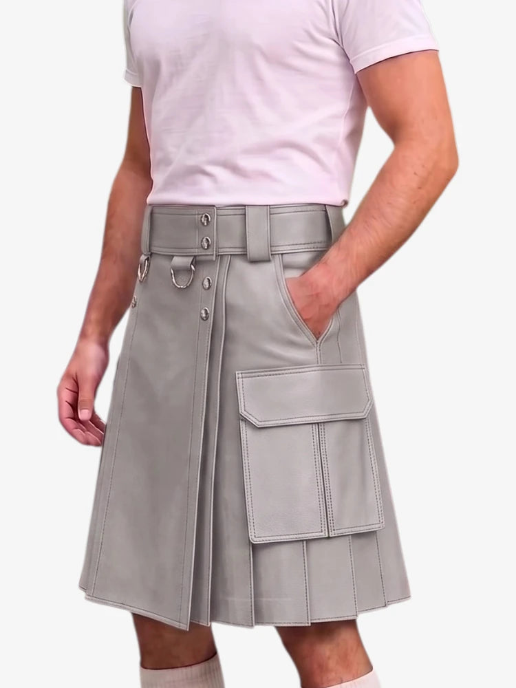 A person wearing a light gray pleated kilt-style skirt with a wide belt, metal hardware, and large cargo pockets, paired with a pale pink T-shirt against a plain light background.