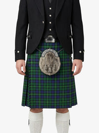 Person wearing a traditional Scottish kilt with a black jacket on a white background