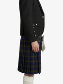 Person wearing a black blazer and plaid kilt on a white background
