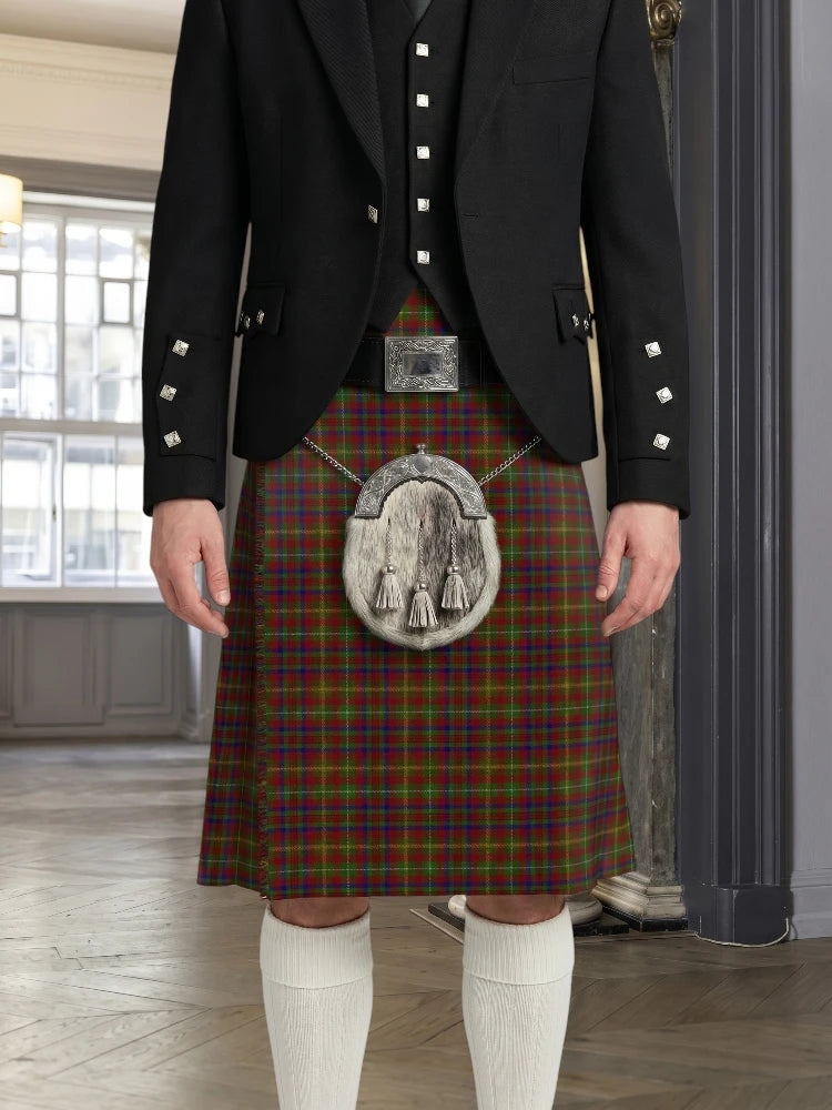Person wearing a traditional Scottish kilt with a tartan pattern in a room with large windows.