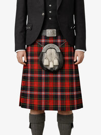 Person wearing a black jacket, red plaid kilt, and gray knee-high socks on a white background