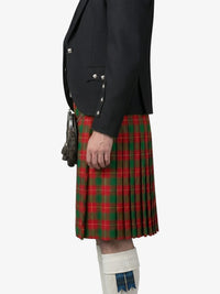 Person wearing a black jacket and red plaid kilt on a white background