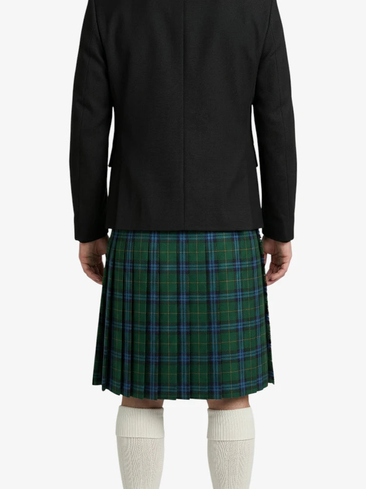Person wearing a black jacket and green plaid kilt on a white background