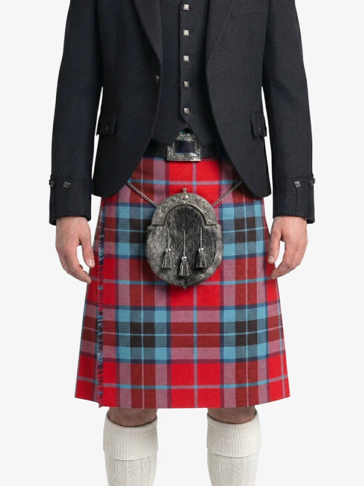 Person wearing a red plaid kilt with a black jacket on a white background