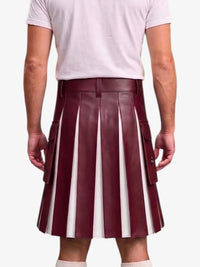 A person shown from the back wearing a pleated leather kilt with vertical burgundy and white stripes, paired with a light pink t-shirt and white socks, against a plain light gray background.