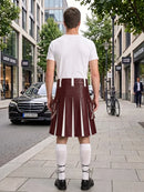 A man viewed from behind wearing a white t-shirt and a dark red leather kilt with white vertical stripes, standing on a city sidewalk.