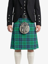 Person wearing a green plaid kilt with a black jacket on a white background