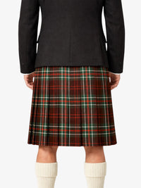 Person wearing a black jacket and red plaid kilt on a white background