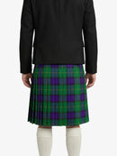 Person wearing a black jacket and green plaid kilt on a white background