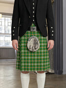 Person wearing a green plaid kilt with a decorative buckle in an indoor setting.