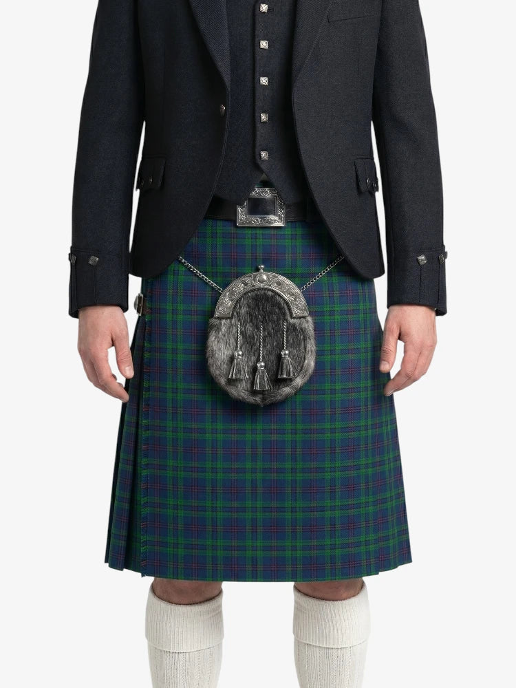Person wearing a green plaid kilt with a dark jacket on a white background