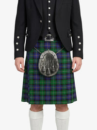 Person wearing a black jacket and green plaid kilt with a silver sporran on a white background