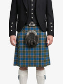 Person wearing a traditional Scottish kilt with a patterned sash on a white background
