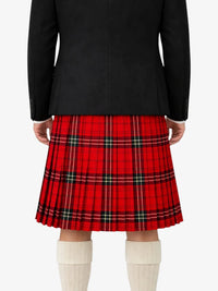 Person wearing a black coat and red plaid kilt on a white background