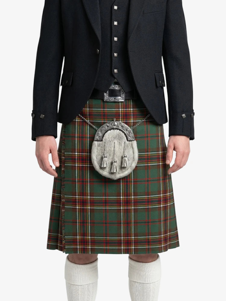 Person wearing a traditional Scottish kilt with a tartan pattern on a white background