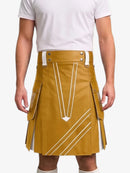 A mustard yellow faux-leather kilt with white graphic line details, worn by a model in a white t-shirt against a light gray background.