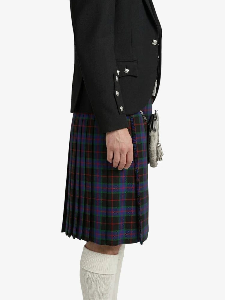 Person wearing a black jacket and plaid kilt on a white background