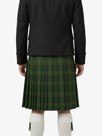 Person wearing a black jacket and green plaid kilt on a white background