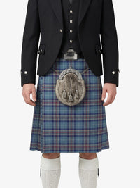 Person wearing a traditional Scottish kilt with a tartan pattern on a white background