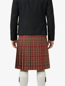Person wearing a black jacket and red plaid kilt on a white background