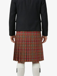 Person wearing a black jacket and red plaid kilt on a white background