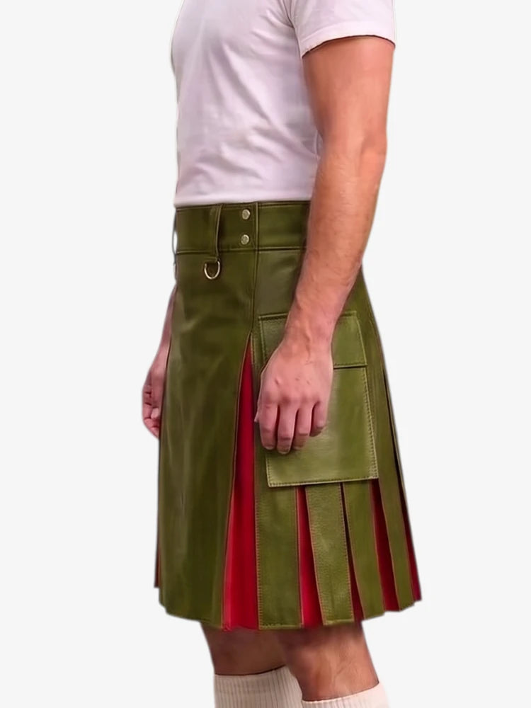A man wearing a green faux-leather kilt with red pleated side panels, paired with a white t-shirt and white socks, shown from the chest down against a light gray background.
