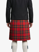 Person wearing a red plaid kilt with a black jacket on a white background
