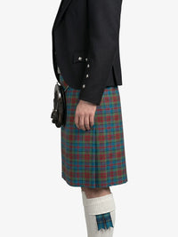 Person wearing a black jacket and plaid kilt on a white background