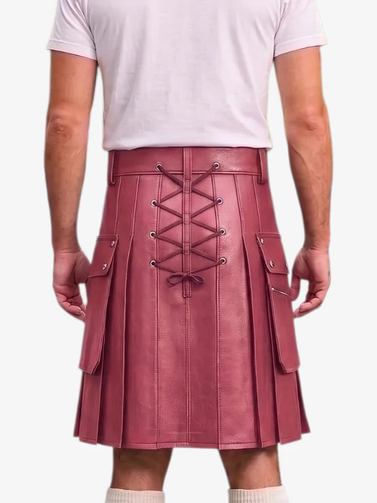 A person shown from the back wearing a pleated kilt in dusty rose pink faux leather with a lace-up back closure and side cargo pockets, paired with a light pink t-shirt and white socks against a light gray background.